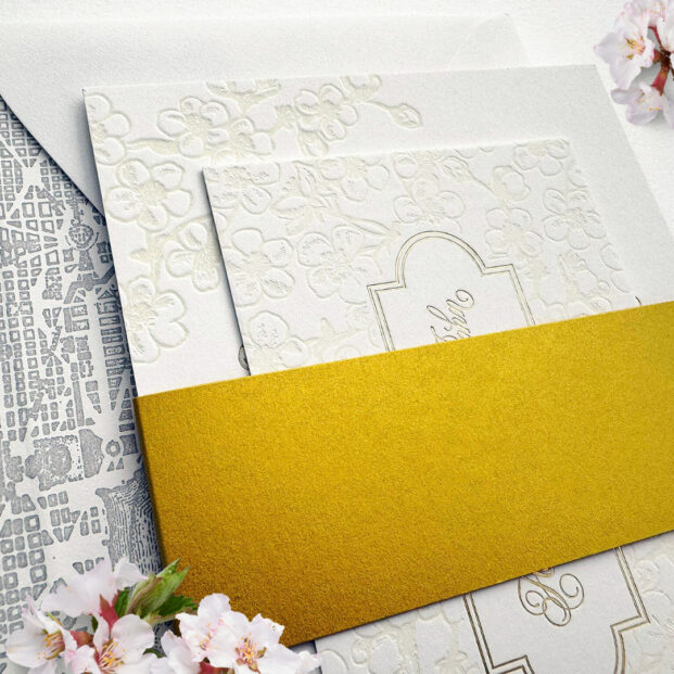 Cherry blossom invitation in letterpress and foil with gold belly band