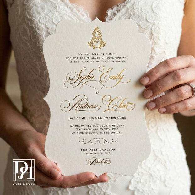 Formal die cut wedding invitation held by bride, featuring letterpress printing and gold foil details